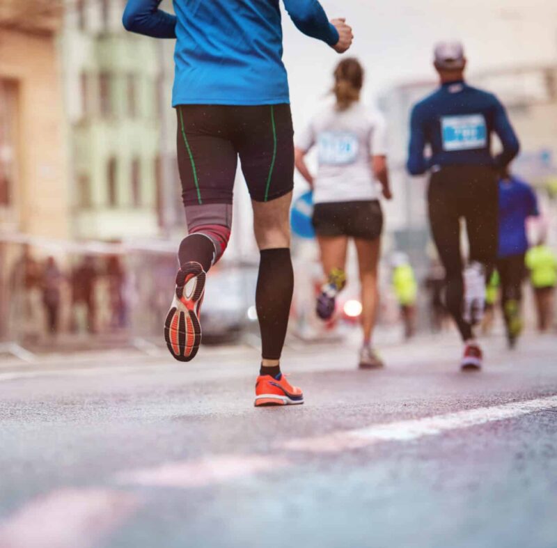 behind a group of people running an organized road race