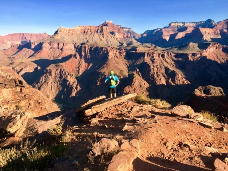 Runner standing atop the Grand Canyon