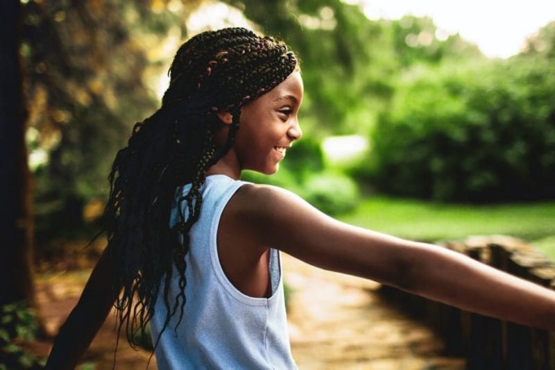 Girl holding her arm up outside