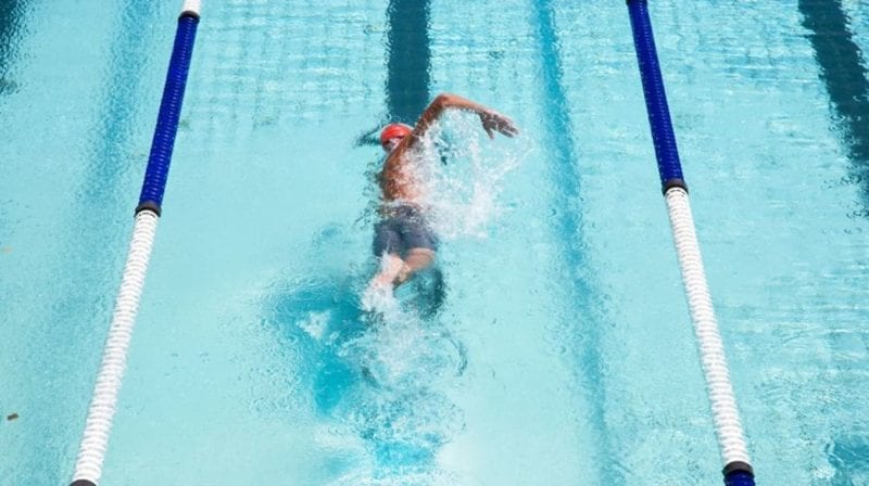 Male lap swimming in pool
