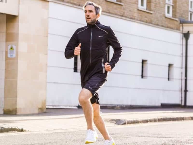 Man running down a city street.