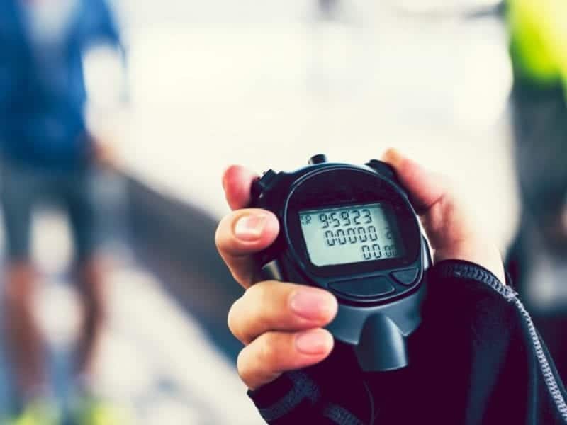 Person holding a stopwatch timing a workout